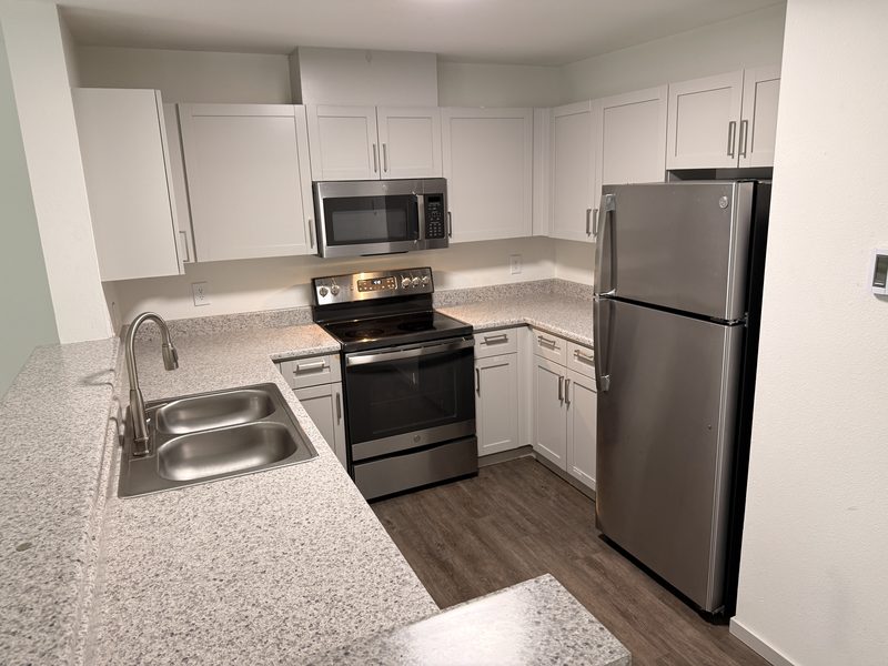Kitchen of an empty unit after a move-in clean by Ultimate Cleaning Service